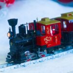 Miniature steam train in festive decor, perfect for adding holiday cheer.