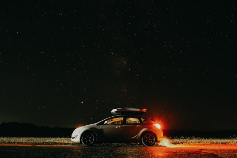 A parked car under a clear starry night sky, capturing the beauty of astronomy.