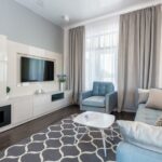 Bright and cozy modern living room featuring minimalist design and blue accents.