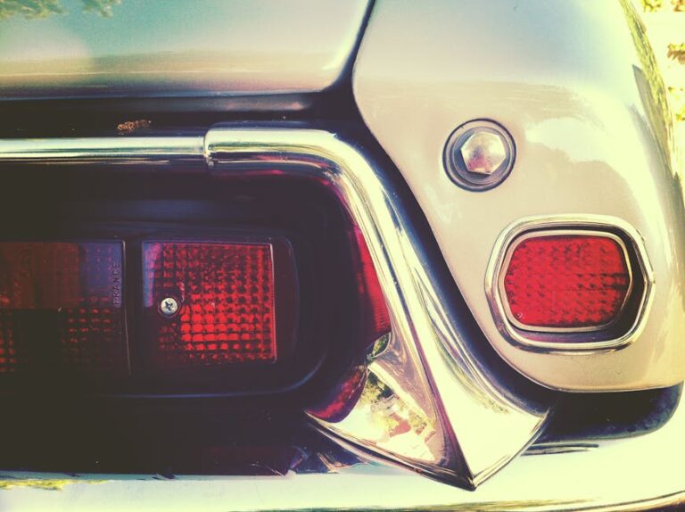 Detailed close-up of a classic car tail light with a vintage aesthetic tone.