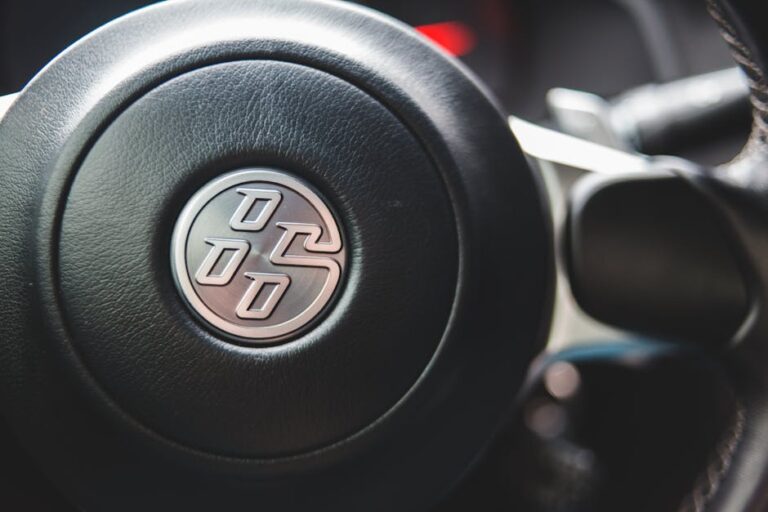 Detailed view of a car steering wheel highlighting design and materials.