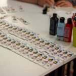 Vibrant DIY card crafting setup with paint and pencils on display.