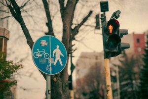 A traffic light and pedestrian sign in Varna, Bulgaria, showcasing an urban winter scene.