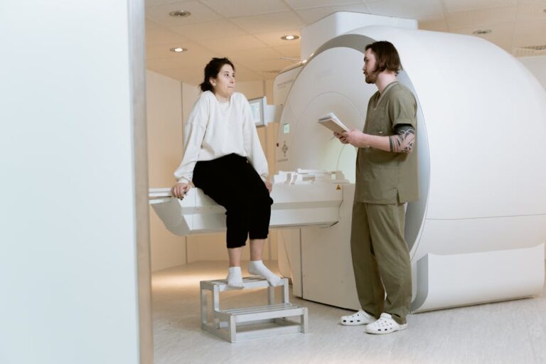 A patient consults with a technician in a modern MRI room, highlighting advanced healthcare facilities.